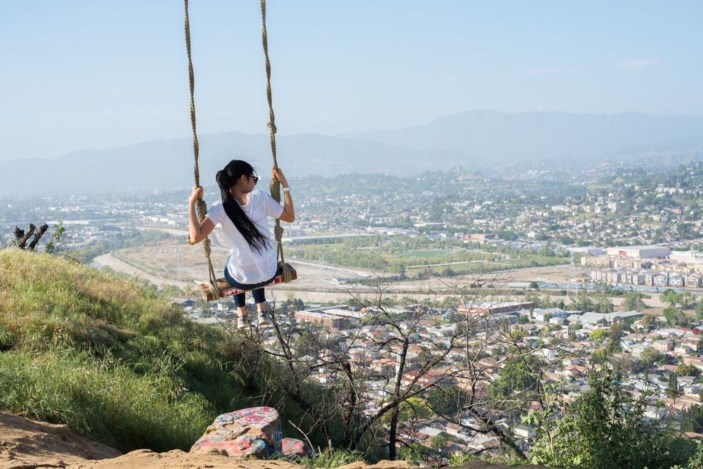 A woman on the rope swing of Elysian Park.