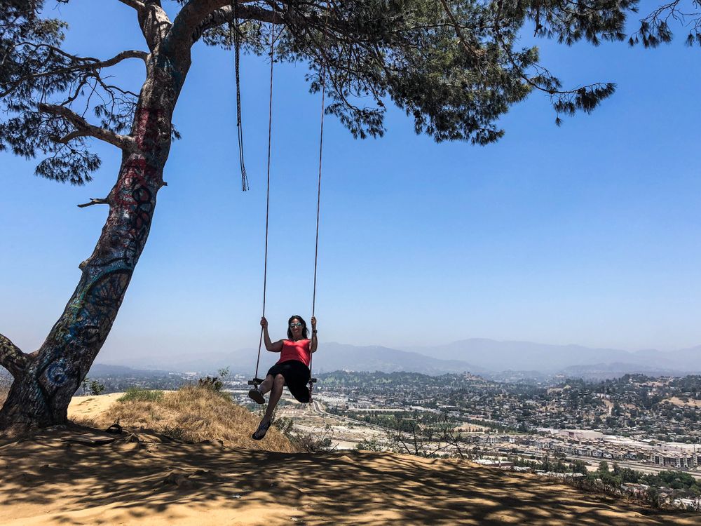 A woman on the rope swing of Elysian Park.