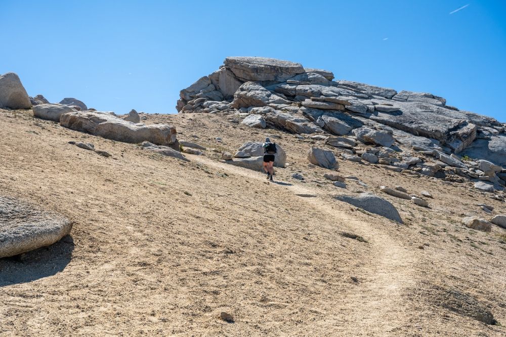 A woman hiking at Alta Peak