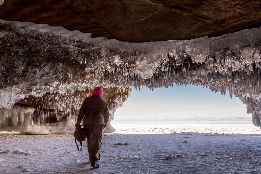 A man exploring the Apostle Islands National Lakeshore Ice Caves