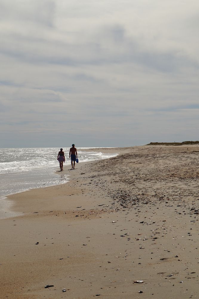 A couple walking at Assateague Beach