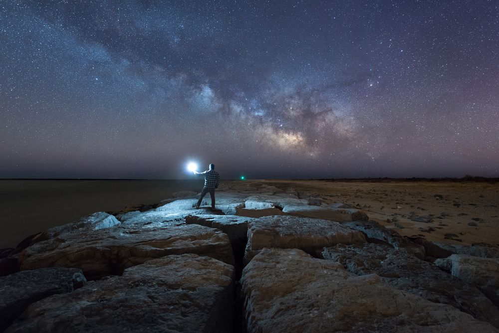 A man admiring the night sky at Scenic Avalon Jetty