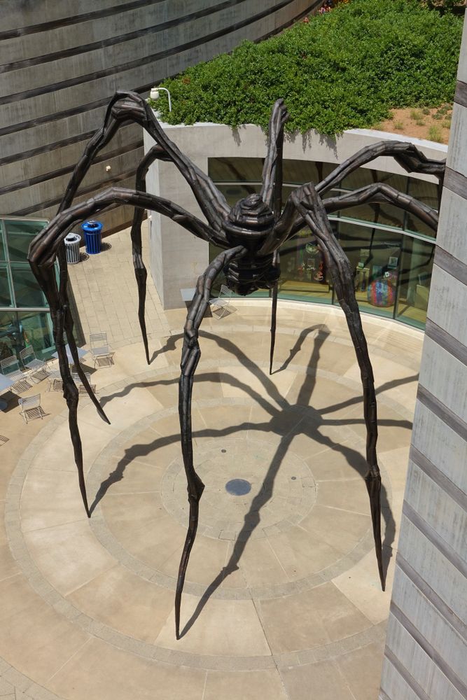 A tall spider-like sculpture on the grounds of Crystal Bridges Museum of American Art