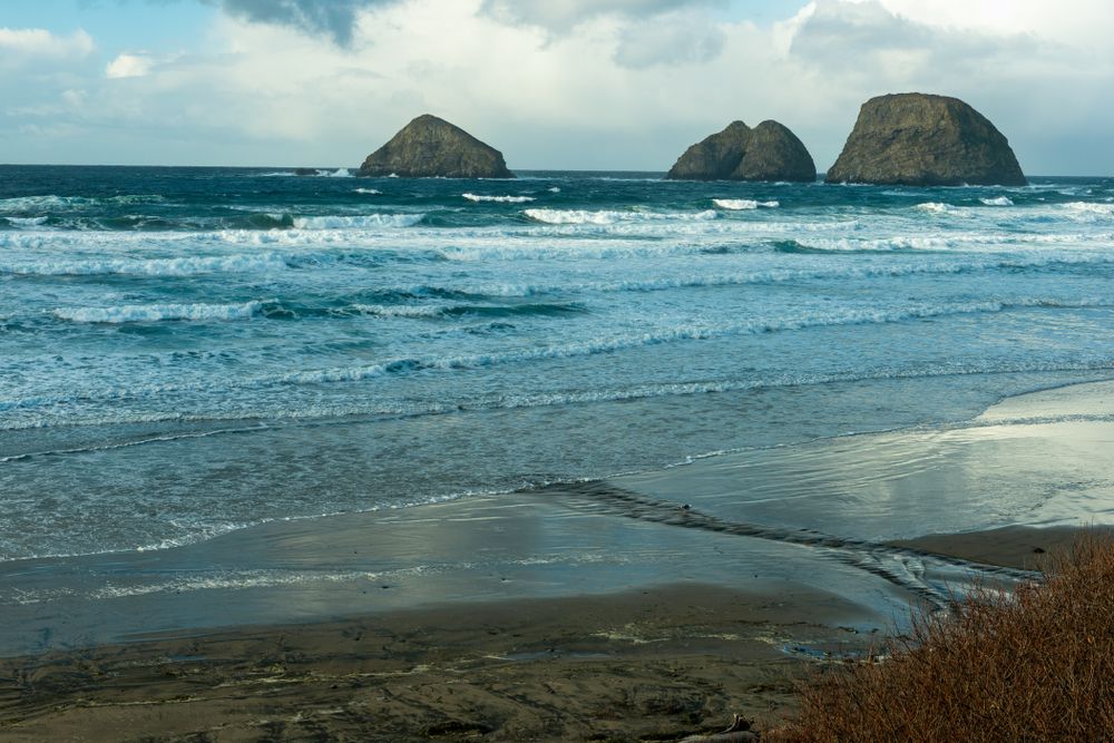 Three arched rocks at the mmiddle of Cape Meares Beach