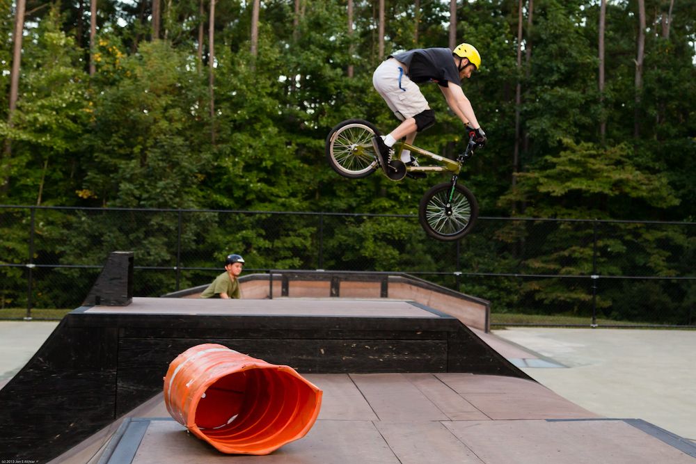 A person doing bicycle tricks at Sk8-Cary Skate Park