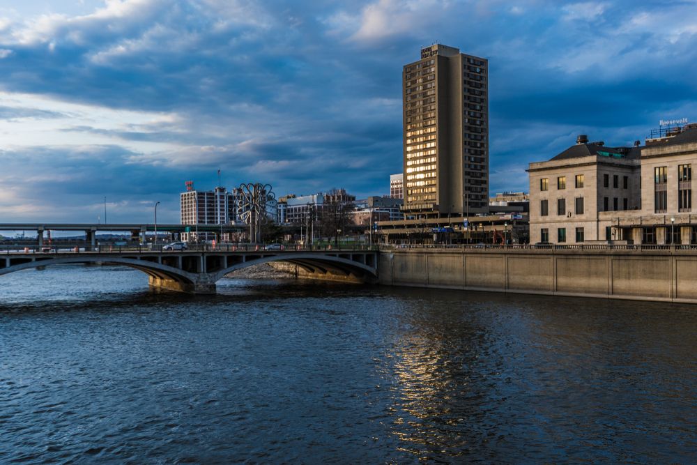 Calm water flowing in Cedar River with cityscape in the background