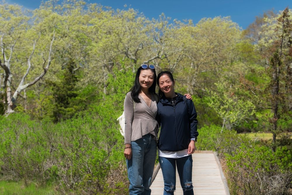 Two woman posing on the boardwalk at Felix Neck Wildlife Sanctuary