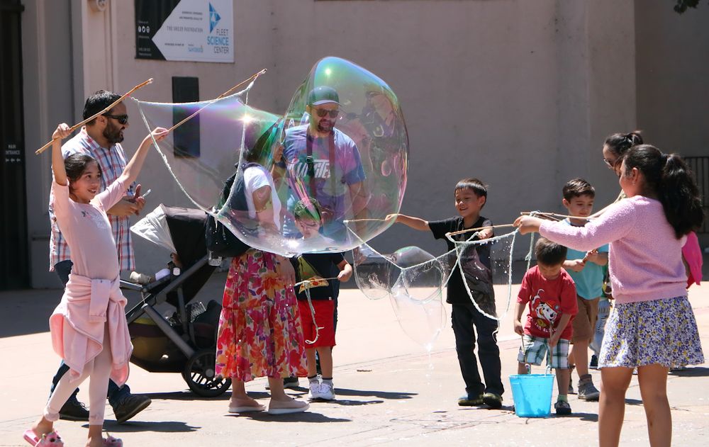 Children playing with huge bubble at Fleet Science Center