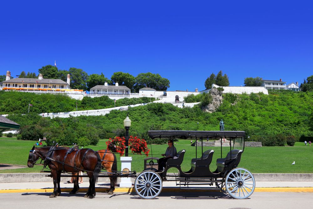 Horse carriage waiting to take the visitors to the Fort Mackinac
