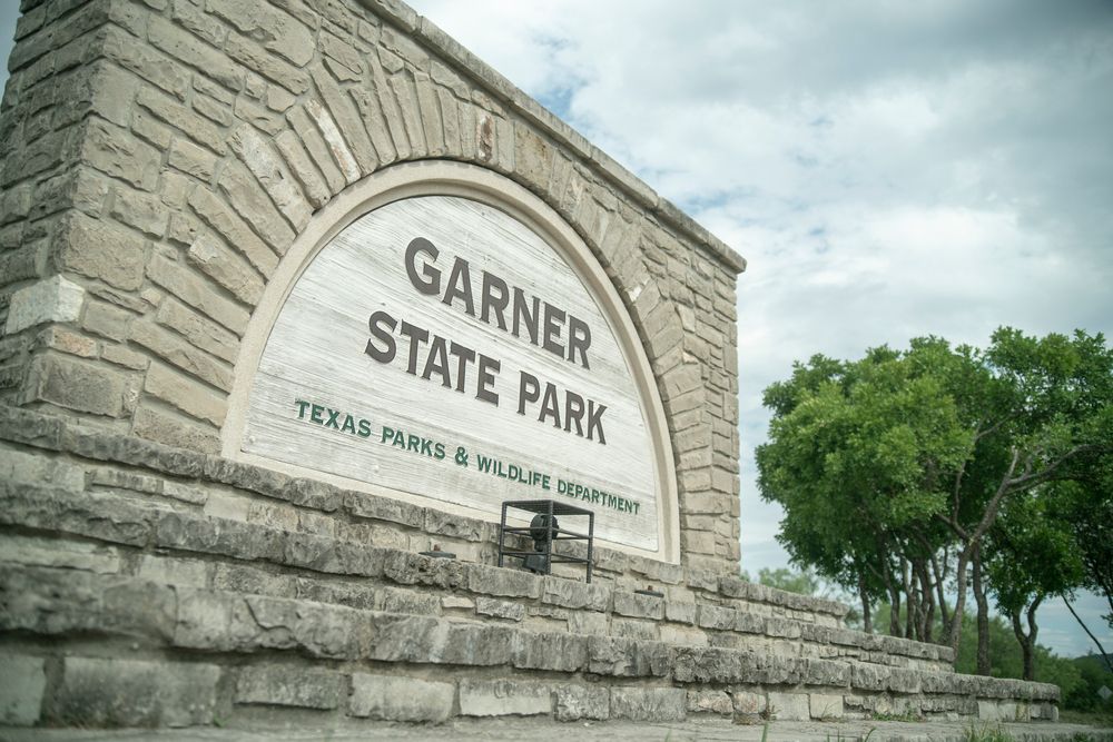 Large stone wall welcoming sign of Garner State Park.
