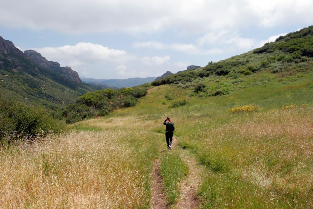 A hiker walking along the Grotto Trail
