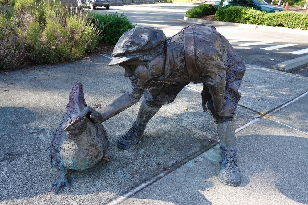 Statue of a boy playing with a chicken at Heritage Park