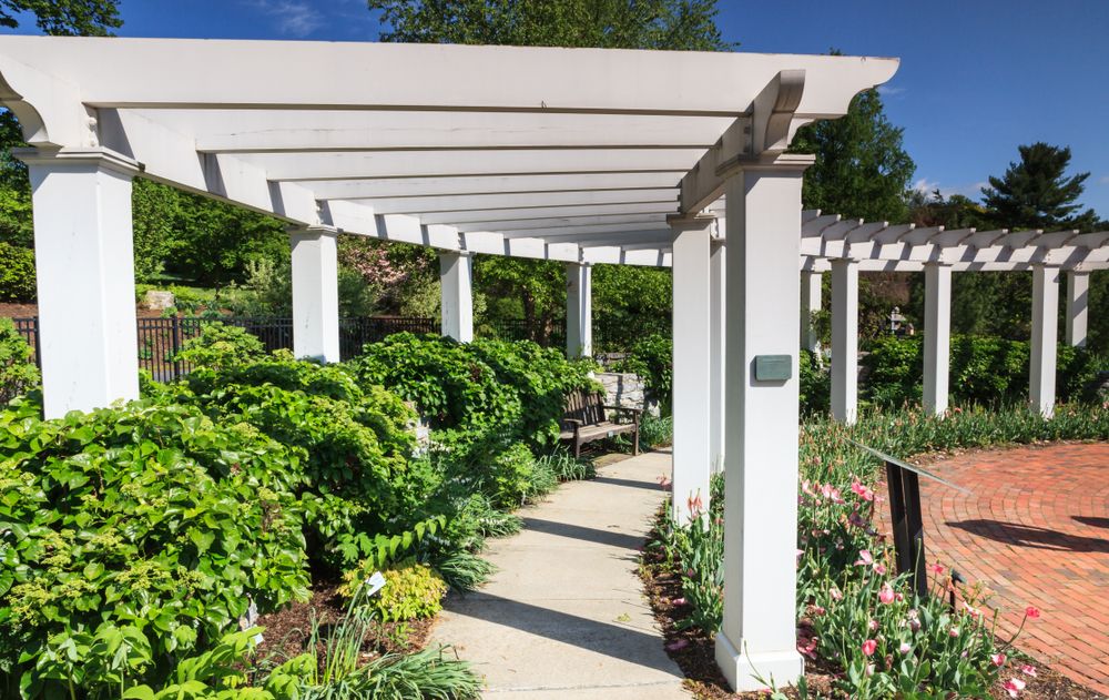 Hershey Gardens' shaded pathway lined with plants and flowers