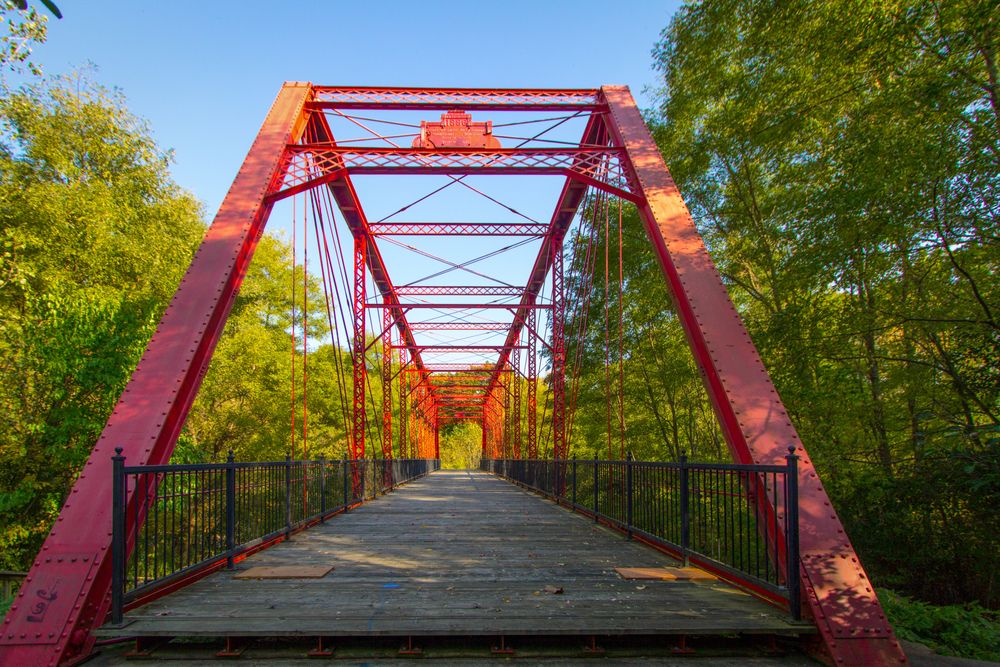 Straight view of the red wooden bridge at Historic Bridge Park