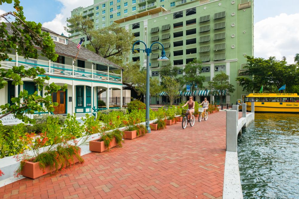 People cycling outside the Historic Stranahan House Museum