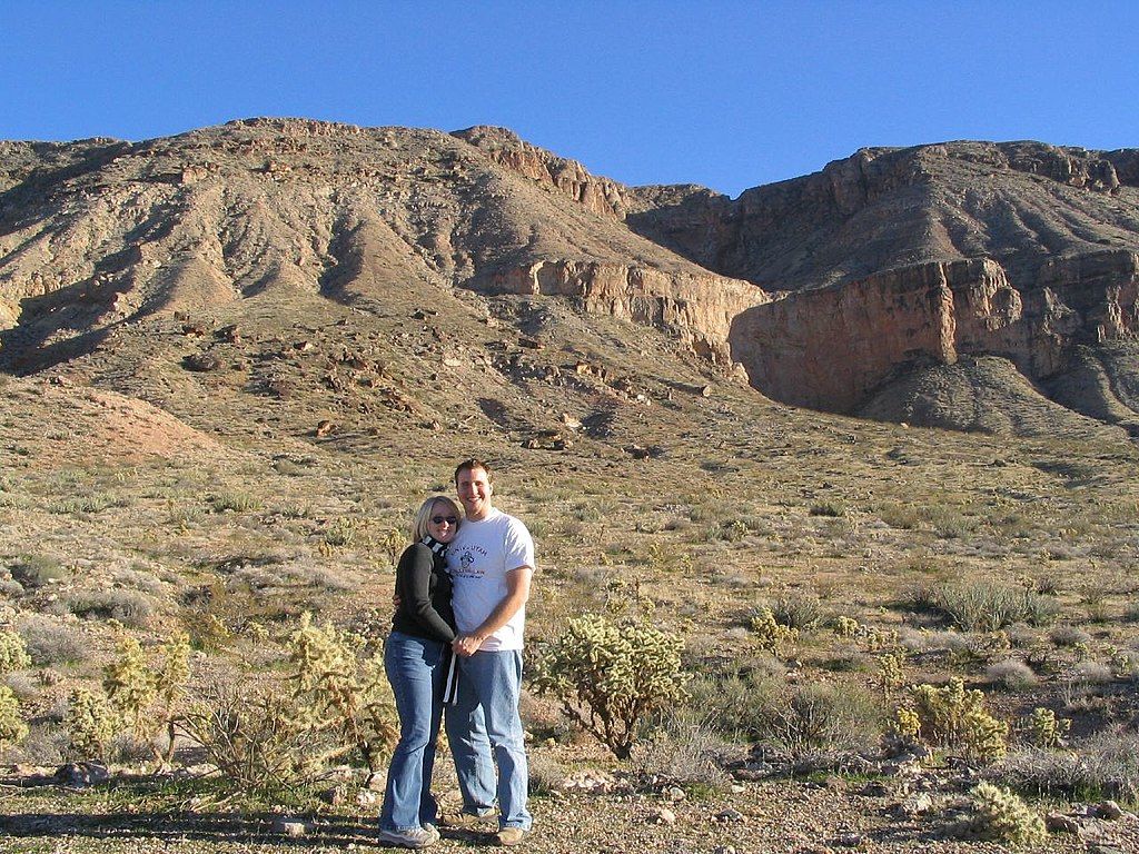 A couple posing in front of the Hurricane Cliffs Trail System