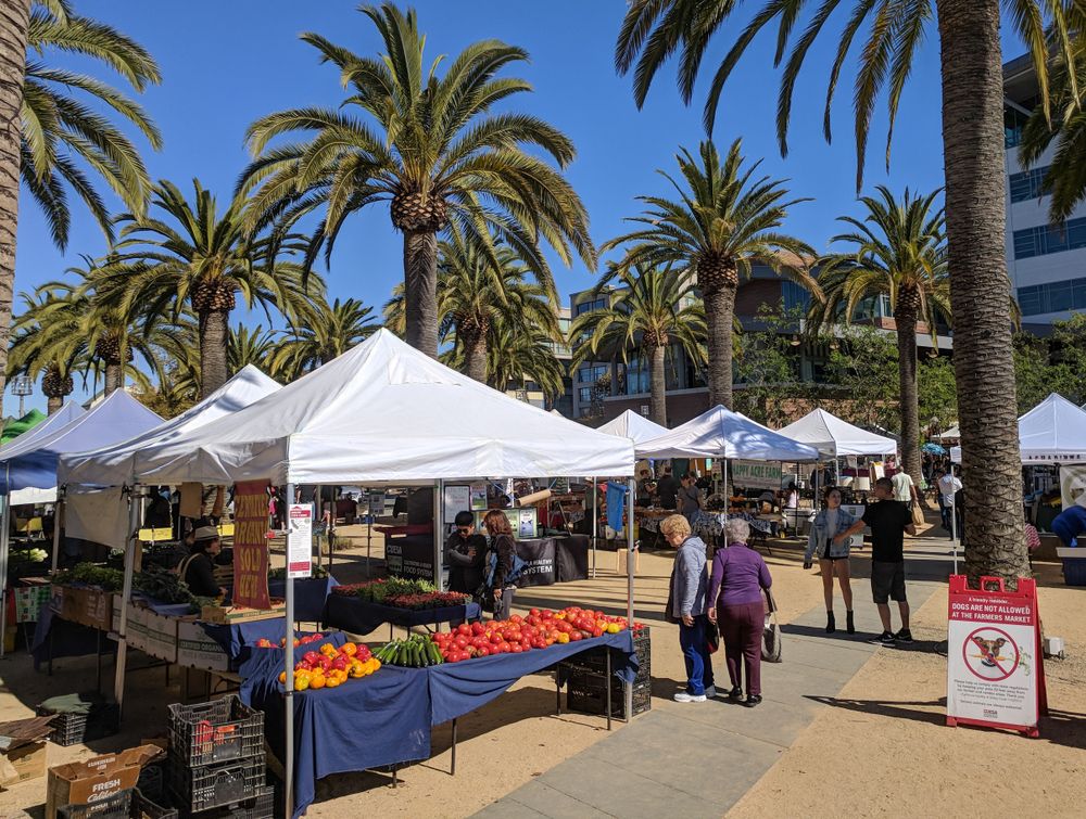 People purchasing vegetables at Jack London Square Farmers’ Market