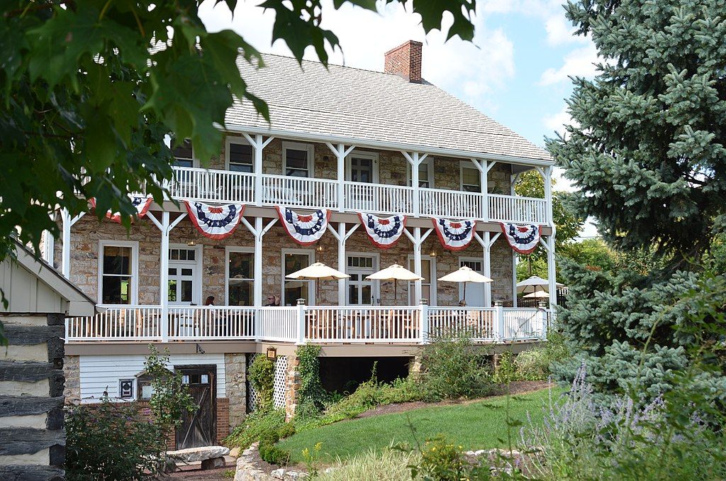 Front view of Jean Bonnet Tavern with lawn and plants in front the building
