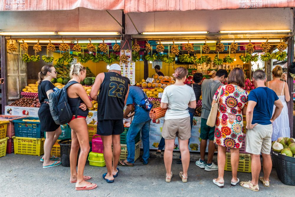 People shopping for fruits at Karon Bazaar