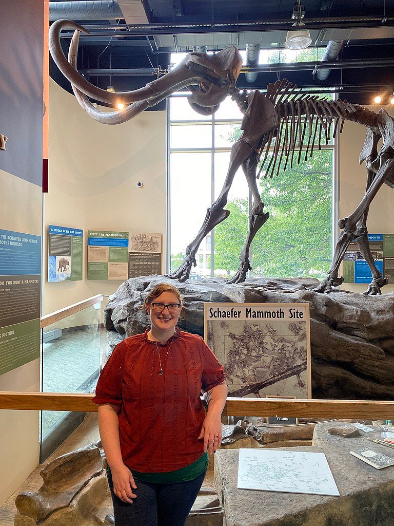 woman posing in front of the exhibit at Kenosha Public Museum