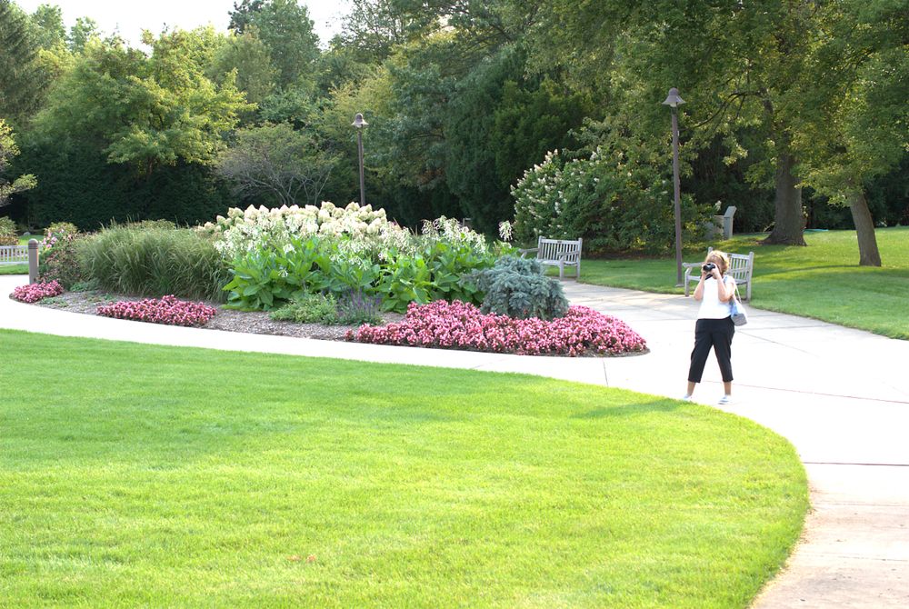 A person taking a picture of Klehm Arboretum and Botanical Garden