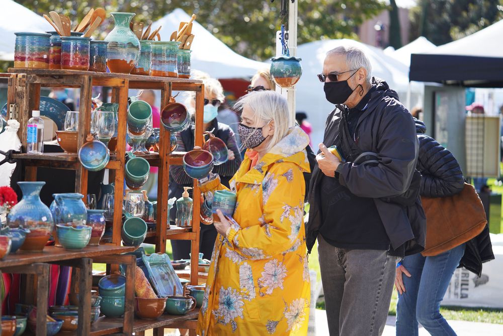 Visitor buying souvenirs from a local vendor at Liberty Station