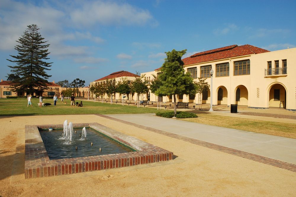 People strolling around with their pets in Liberty Station