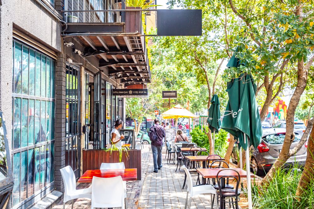 Tables at a restaurant with a street view at Maboneng Precinct