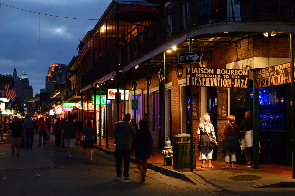 People waiting outside the Maison Bourbon Jazz Club at night