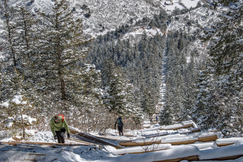Hikers climbing the Manitou Springs Incline during snow