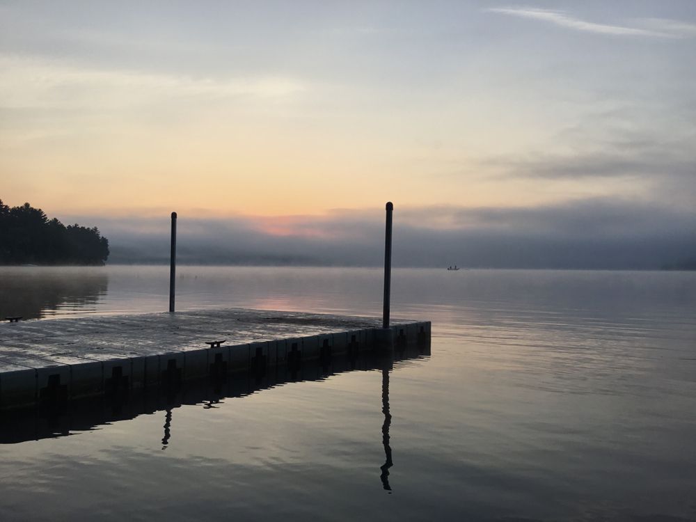 Wooden dock at Massabesic Lake during sunrise