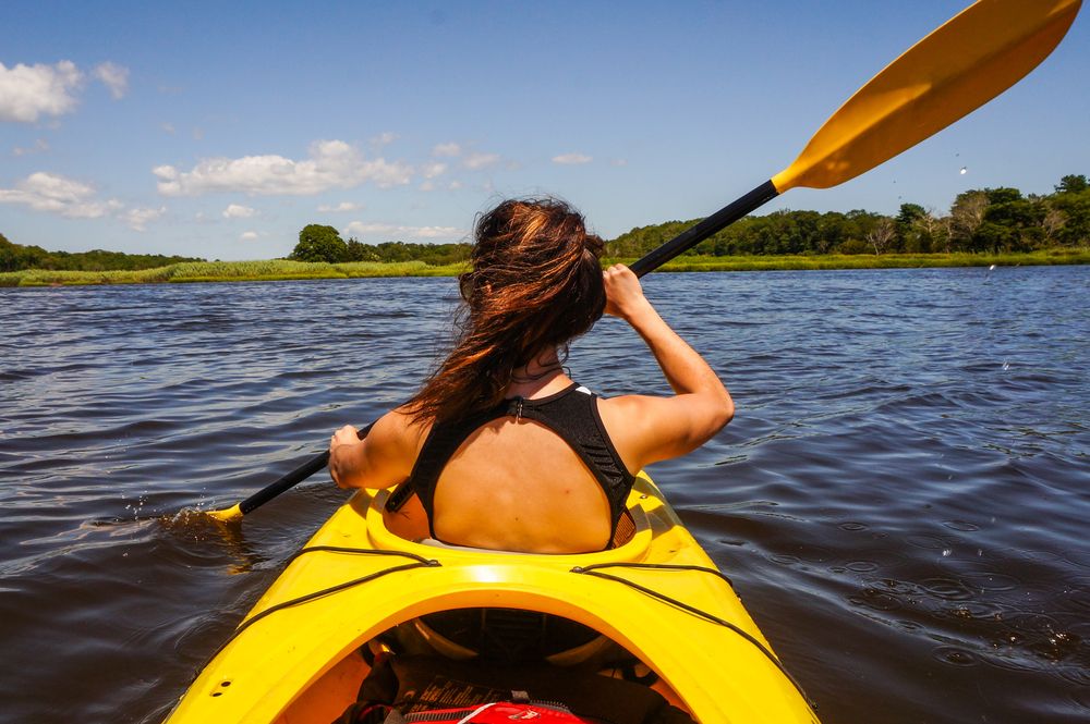 A woman kayaking in Westport River