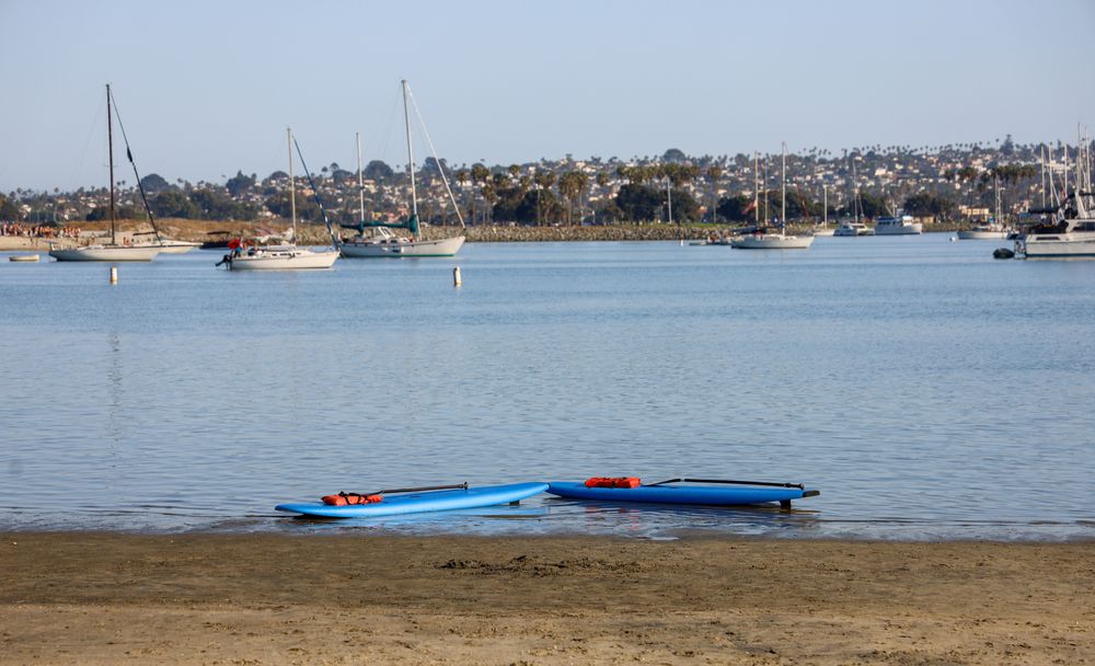 Empty paddle boards at the shore of Mission Beach