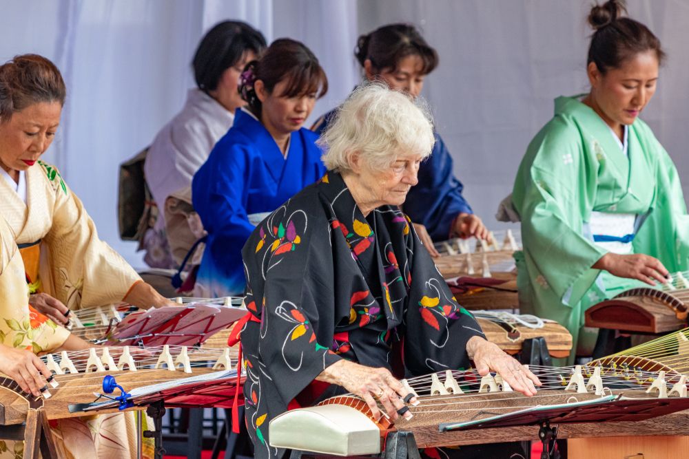 Asian women playing their traditional musical instrument at Morikami Museum and Japanese Gardens