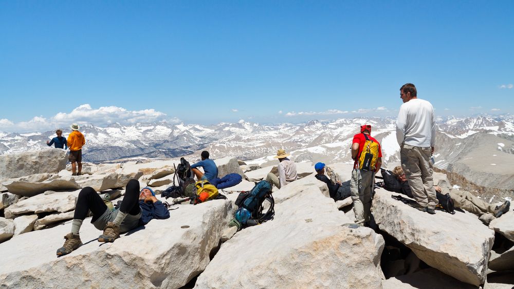 Hikers resting on the peak of Mount Whitney