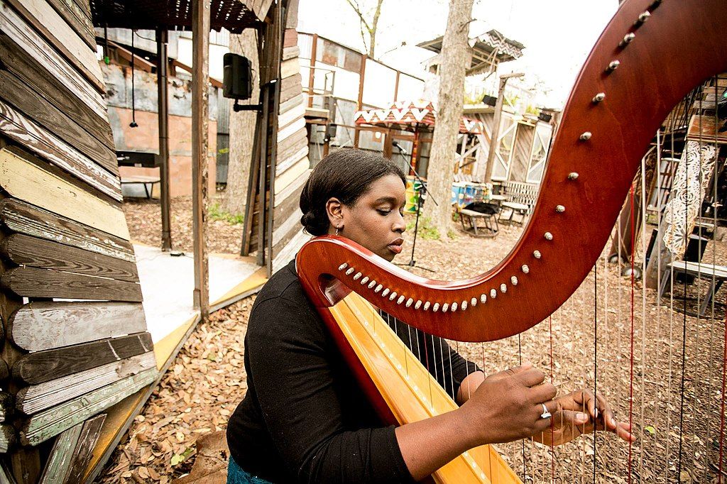 A woman playing harp at Music Box Village