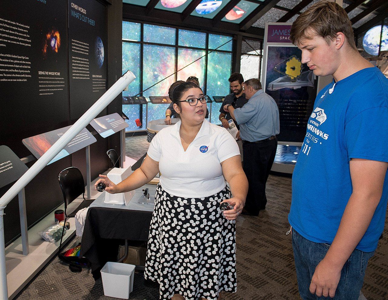A women explaining about space to a visitor at NASA Goddard Space Flight Center