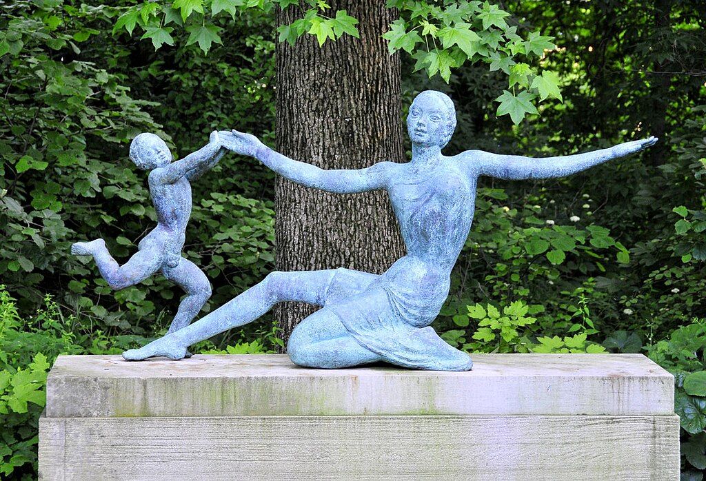 Sculpture of a woman and a kid playing at Newfields