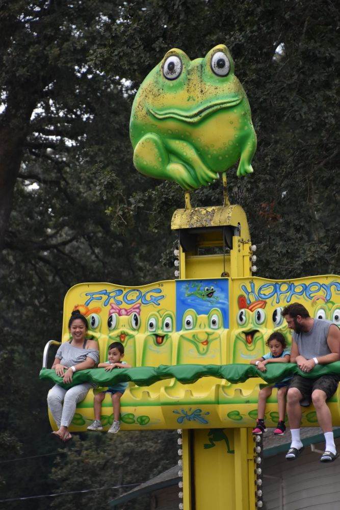 A family enjoying the frog hopper ride at Oaks Amusement Park