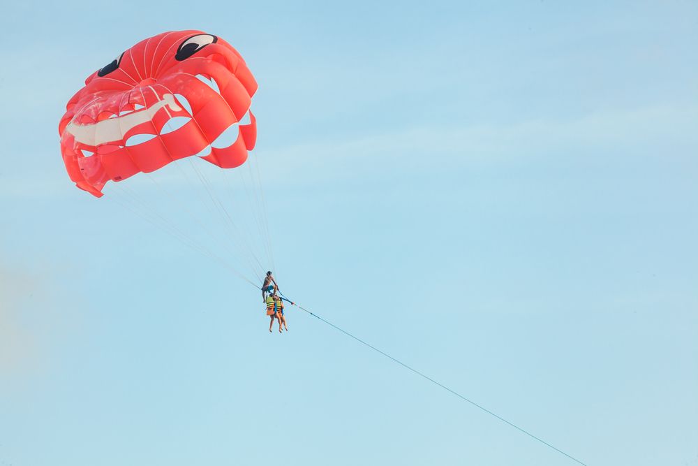 A young couple enjoying parasailing at Karon Beach