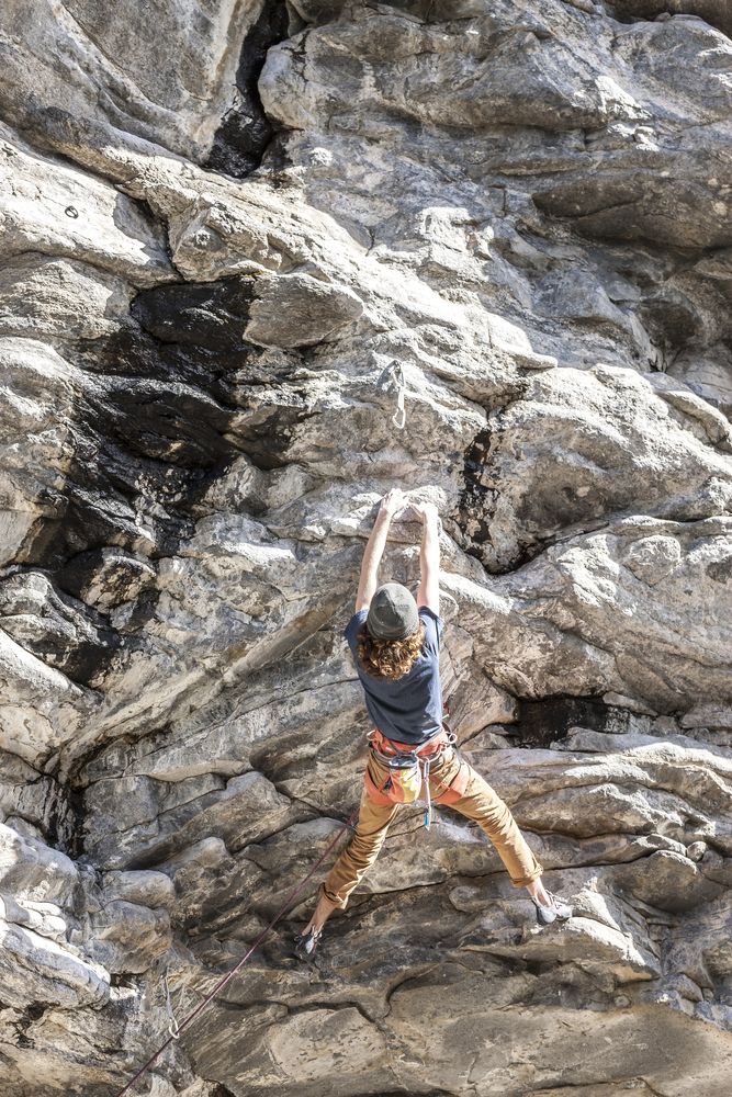 A man climbing the rock at Q'emiln Park