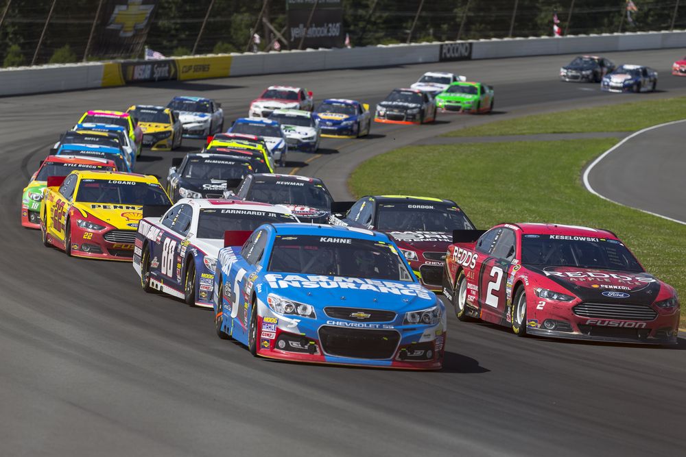 A bunch of race cars along the raceway.