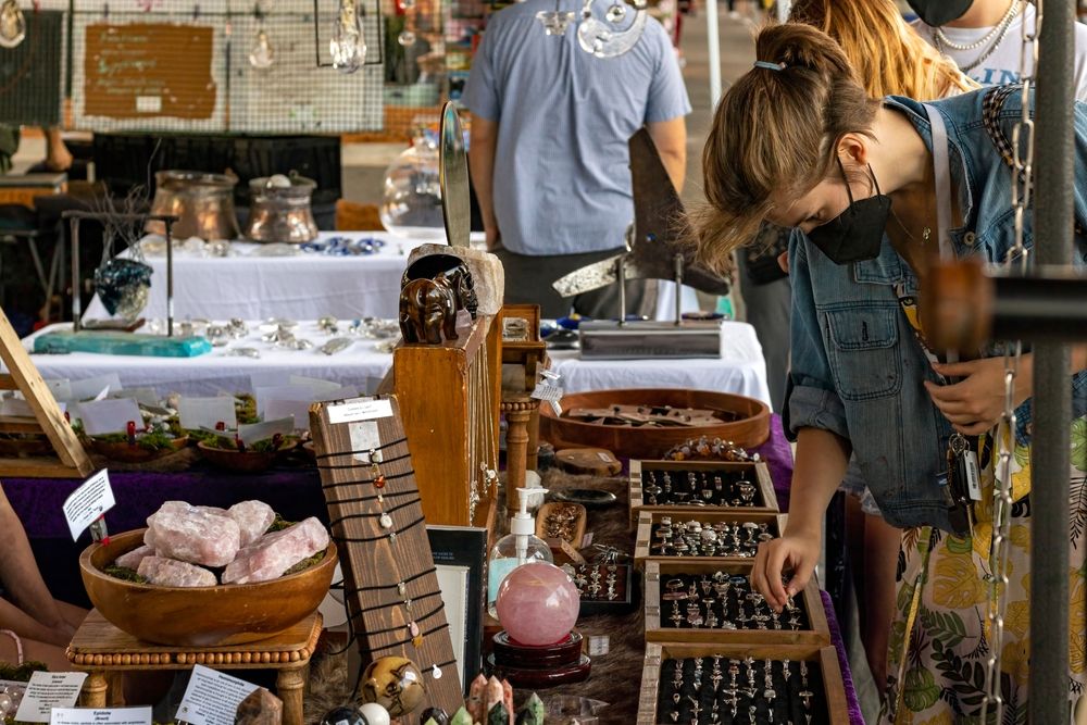 Woman looking at the crystals that are kept for sale at Riverside Arts Market