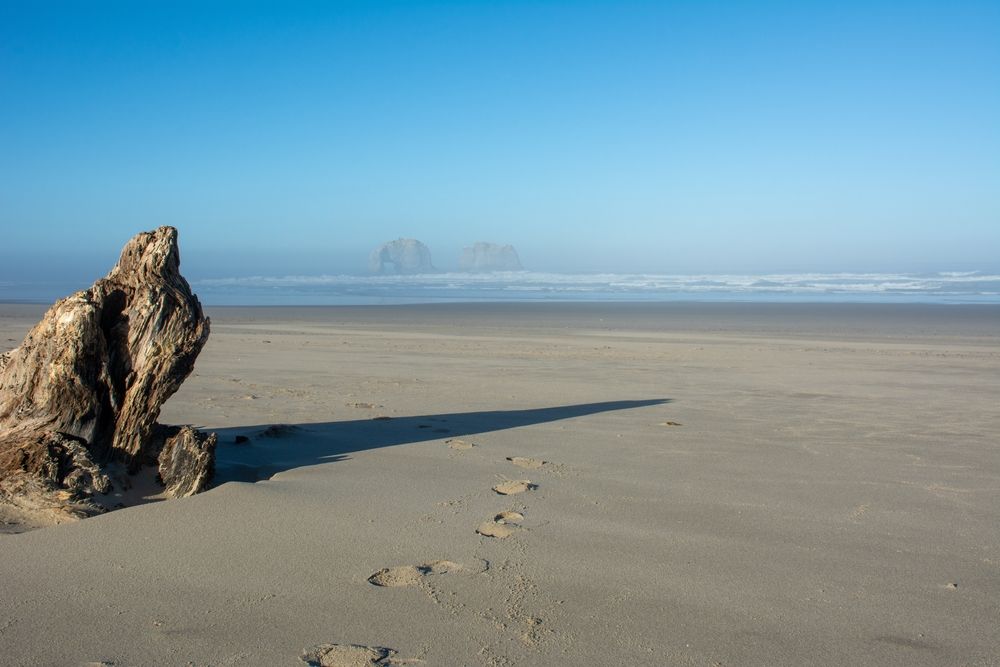 Footprints on the sand of Rockaway Beach.