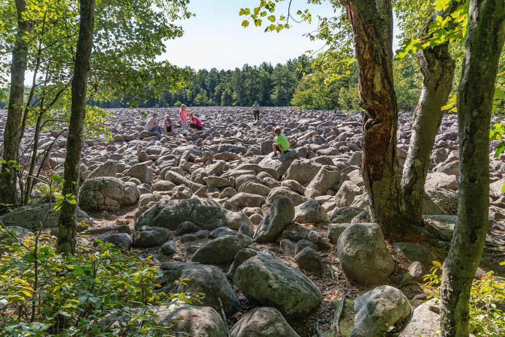 A few people sitting on top of big boulders.