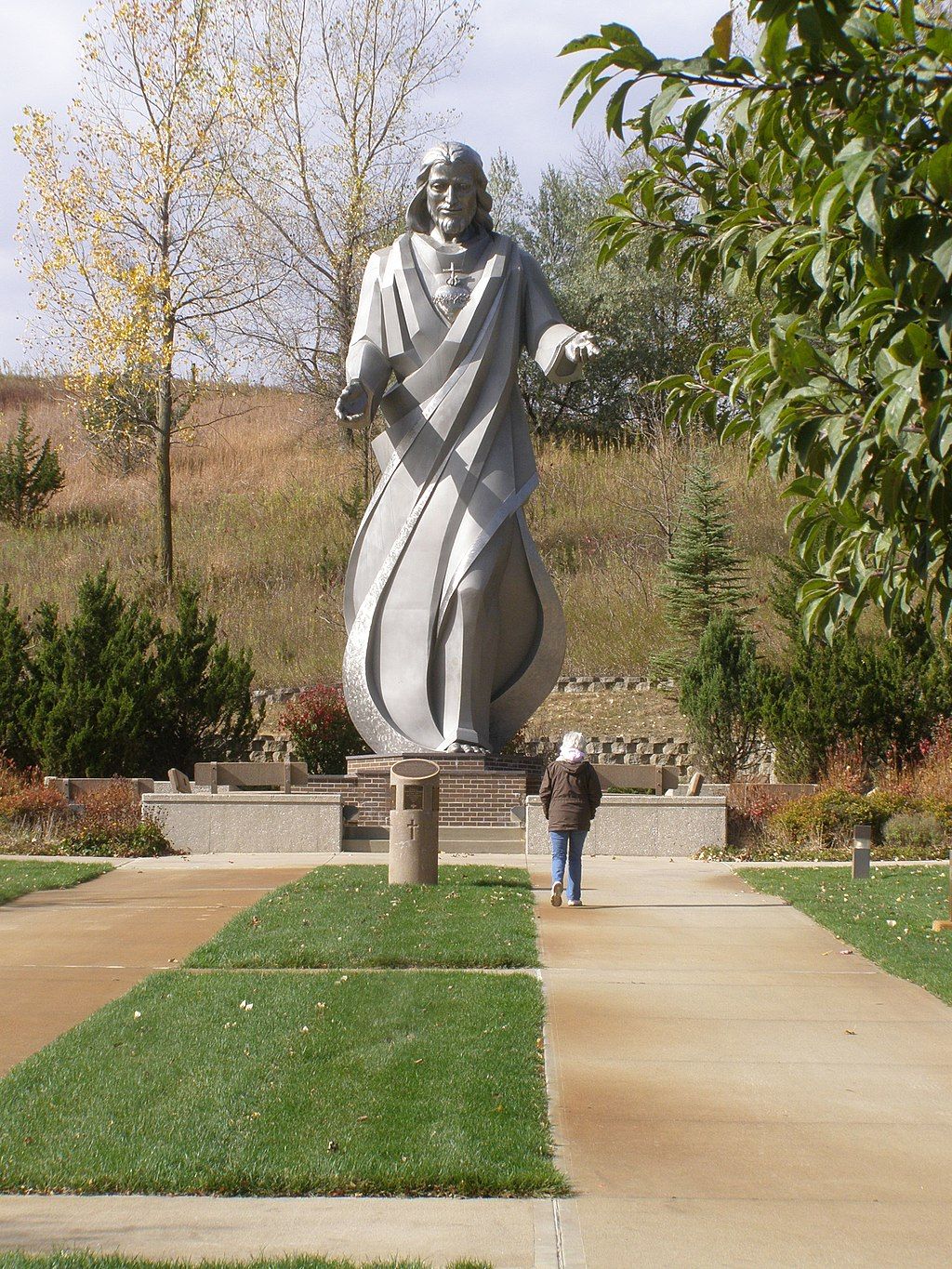 A person admiring a statue at Trinity Heights
