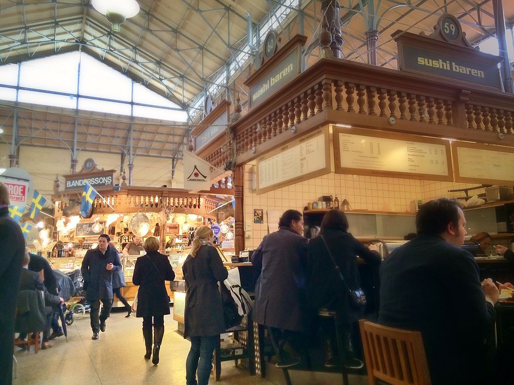 People shopping at the food outlets in Saluhallen