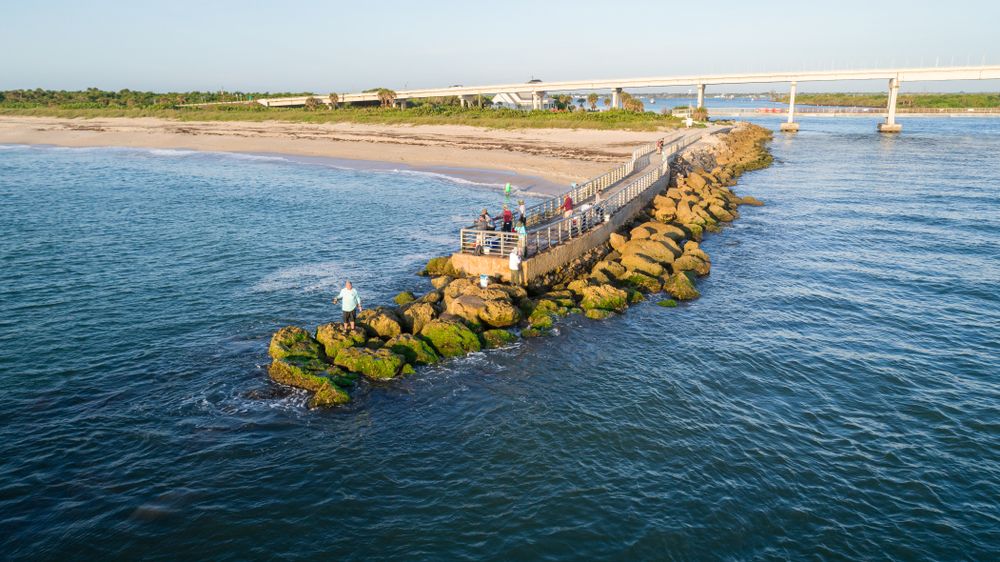 People enjoying the view of the ocean from the pier in Sebastian Inlet State Park