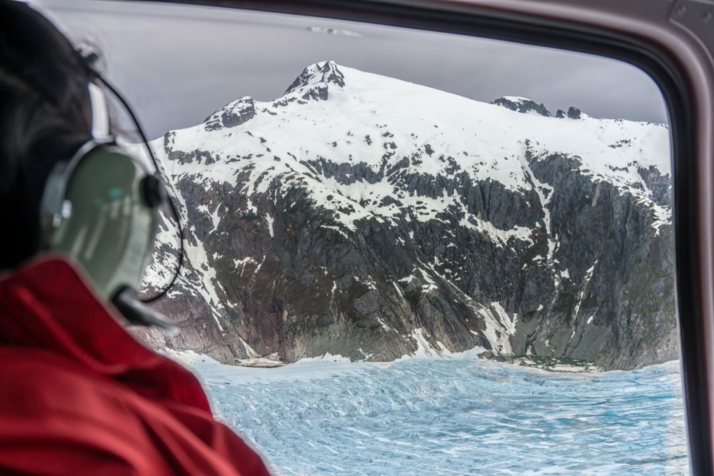Passenger looking at a glacier while on Skagway Glacier Helicopter Tour