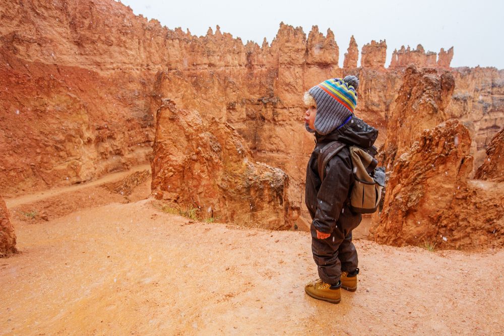 Cute little boy hiking Bryce Canyon National Park during winter